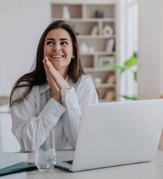 Excited,Brunette,Caucasian,Young,Adult,Woman,In,White,Shirt,Sitting